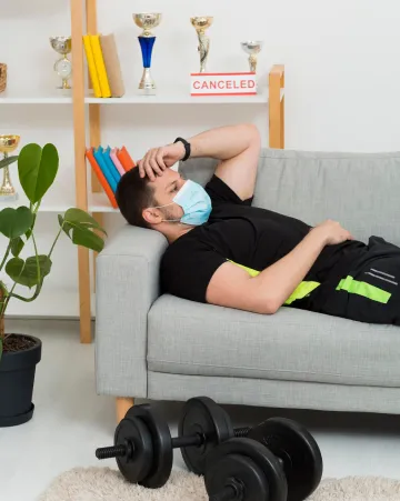 Sad man sitting and thinking about a canceled event, looking stressed and disappointed