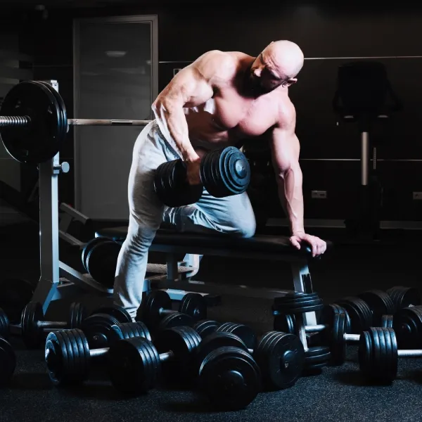 man-with-dumbbell-looking-shoulder man with dumbbell looking shoulder
