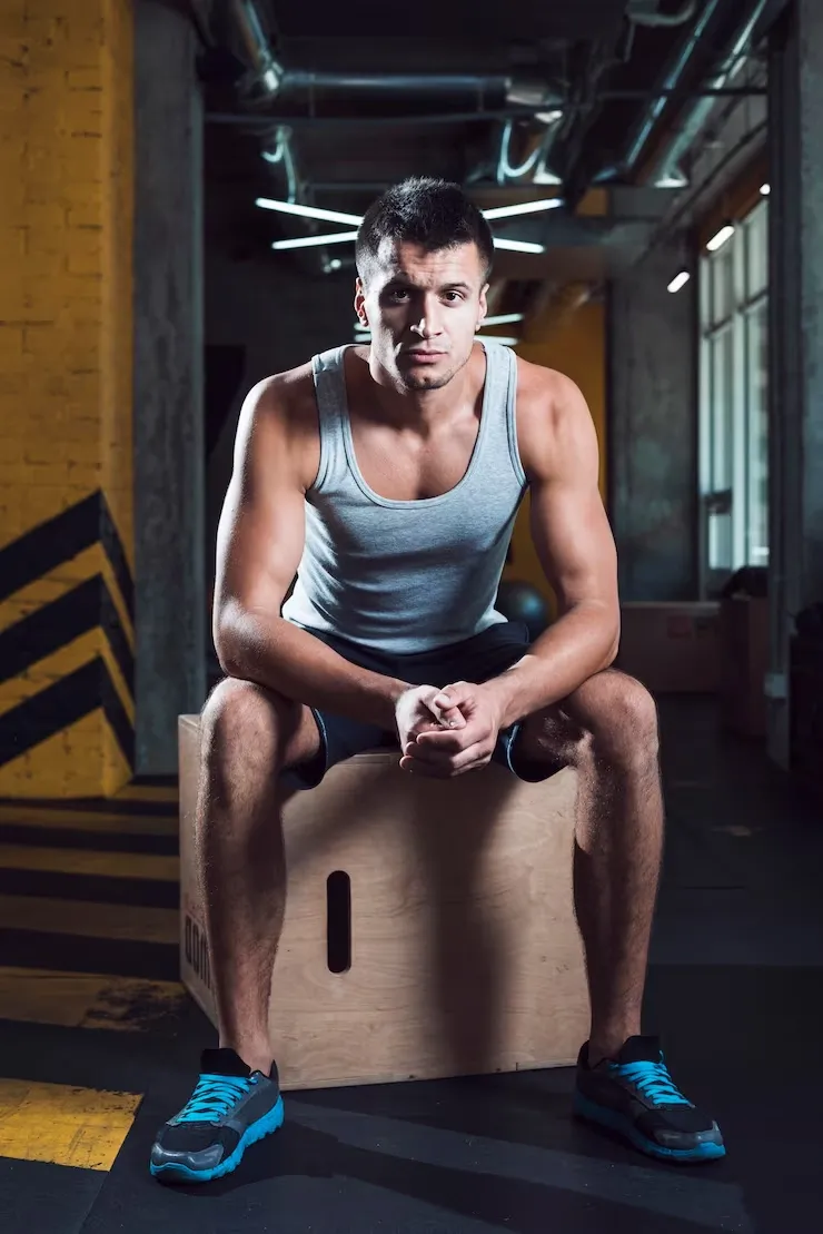 portrait-man-sitting-wooden-box-gym_23-2147949549 Portrait of a fit man sitting on a wooden box in the gym after workout