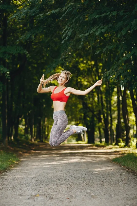 Sporty girl jumping during outdoor fitness training for strength and agility