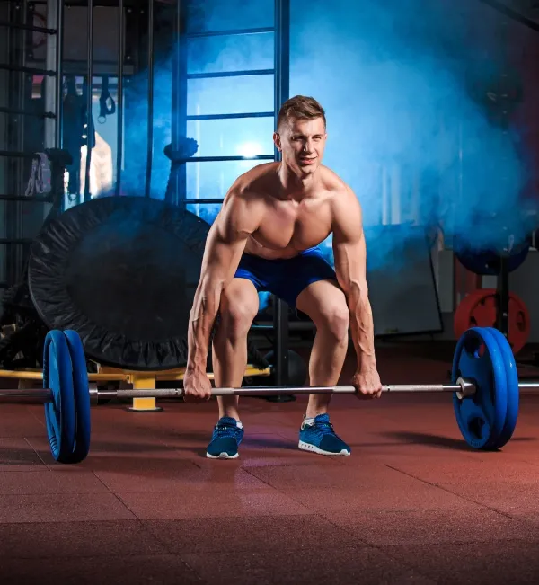 young-man-doing-exercises-with-barbell-gym young man doing exercises with barbell gym