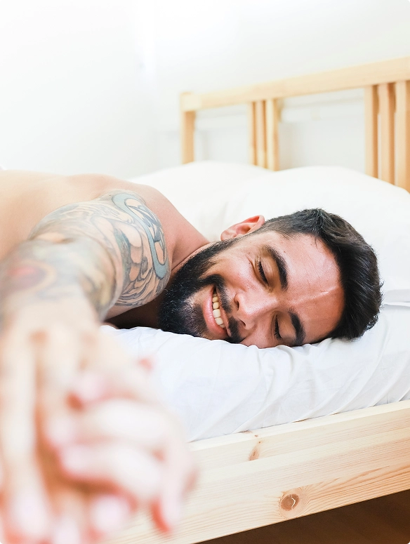 happy-men-lying-on-bed