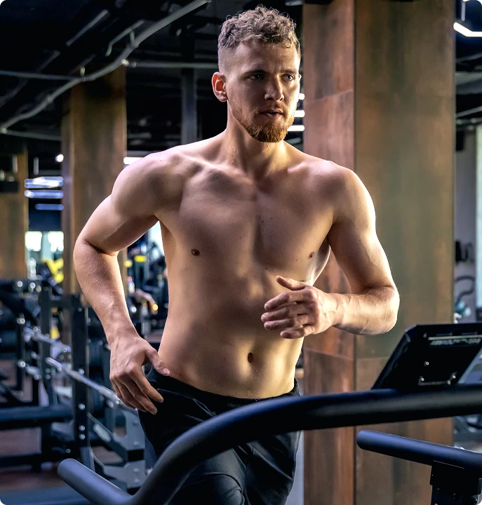 Man running on treadmill in gym