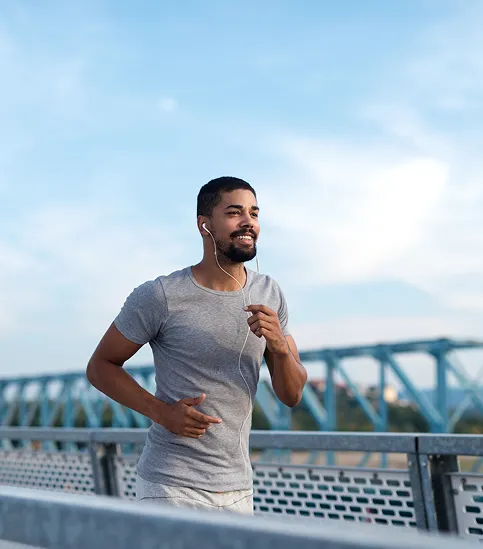 Active man jogging outdoors after trt therapy