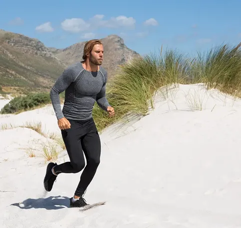 Athletic man running outdoors showing trt benefits