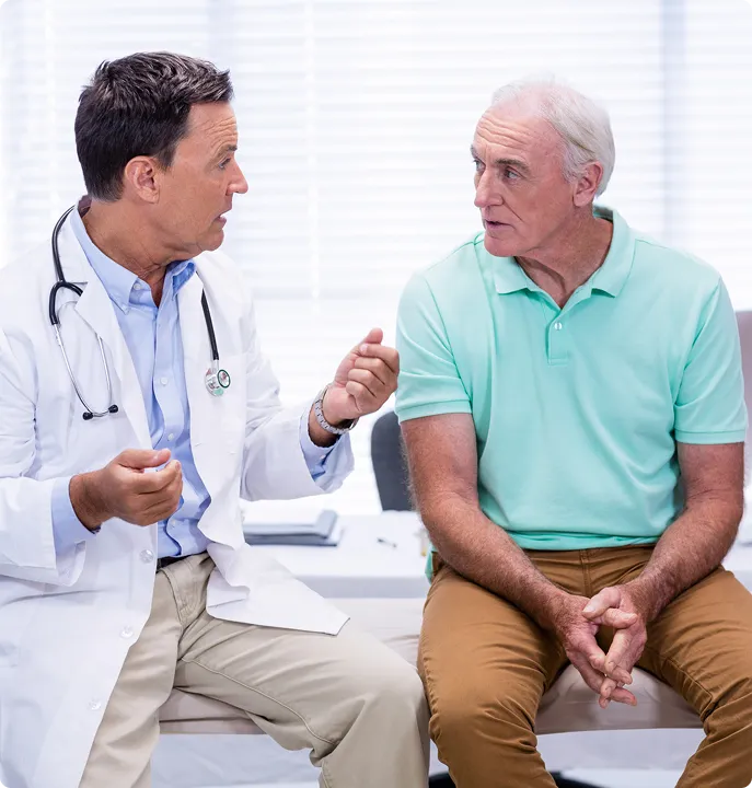 Doctor explaining trt cost breakdown to senior patient