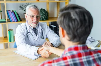Doctor shaking hands with patient after trt consultation
