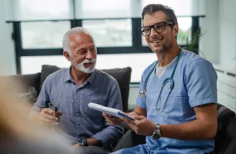Healthcare provider discussing trt pricing with senior patient