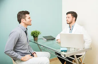 Young man consulting doctor about trt treatment cost
